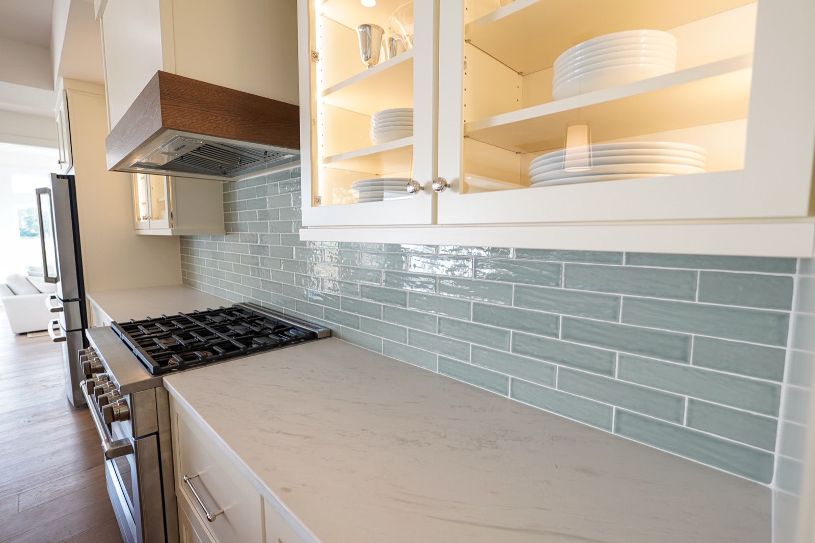Blue-green glass subway tile behind a range by Shoreline Cabinet Company, Wilmington NC