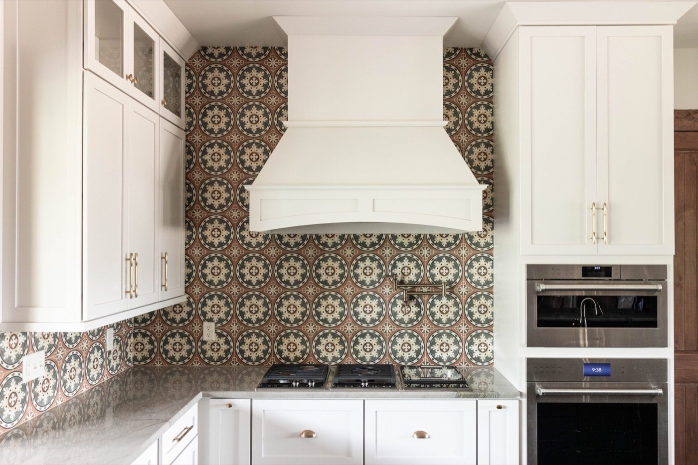 Covered Bridge Cabinetry Range hood with tile backsplash, available at Shoreline Cabinet Company in Wilmington, NC