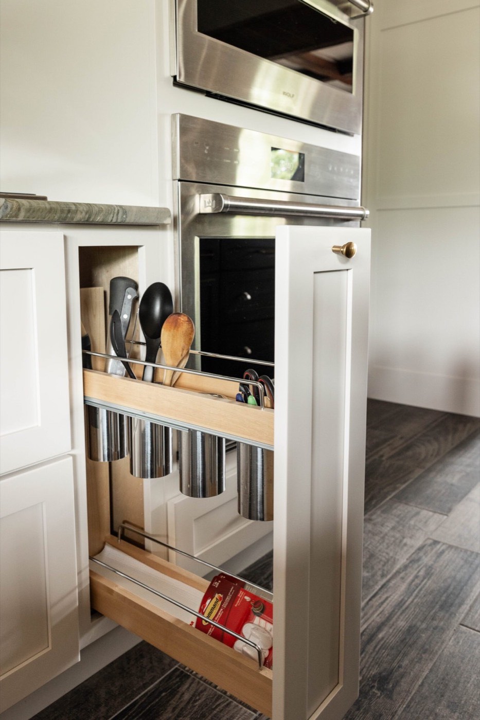 Covered Bridge Cabinetry Pull-out utensil storage, available at Shoreline Cabinet Company in Wilmington, NC