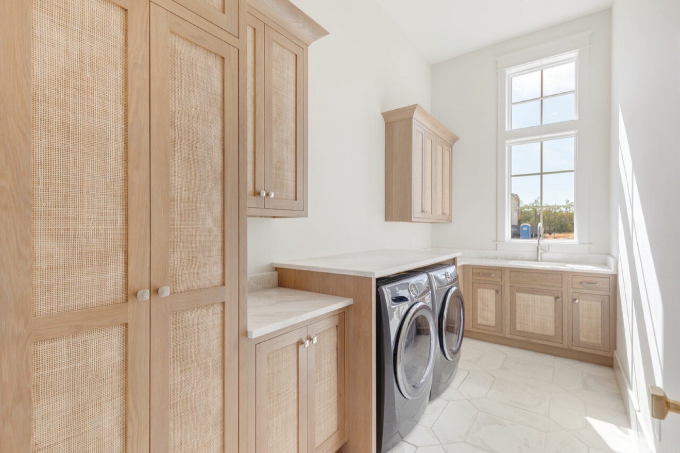 Covered Bridge Cabinetry Laundry room (Farmington inset, white oak w/ wicker inserts), available at Shoreline Cabinet Company in Wilmington, NC