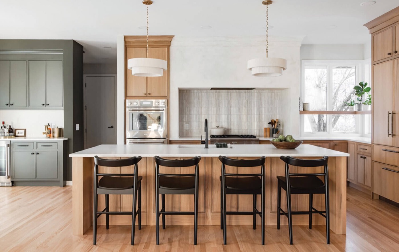 Dura Supreme Cabinetry Natural quarter-sawn white oak kitchen and living room, available at Shoreline Cabinet Company in Wilmington, NC