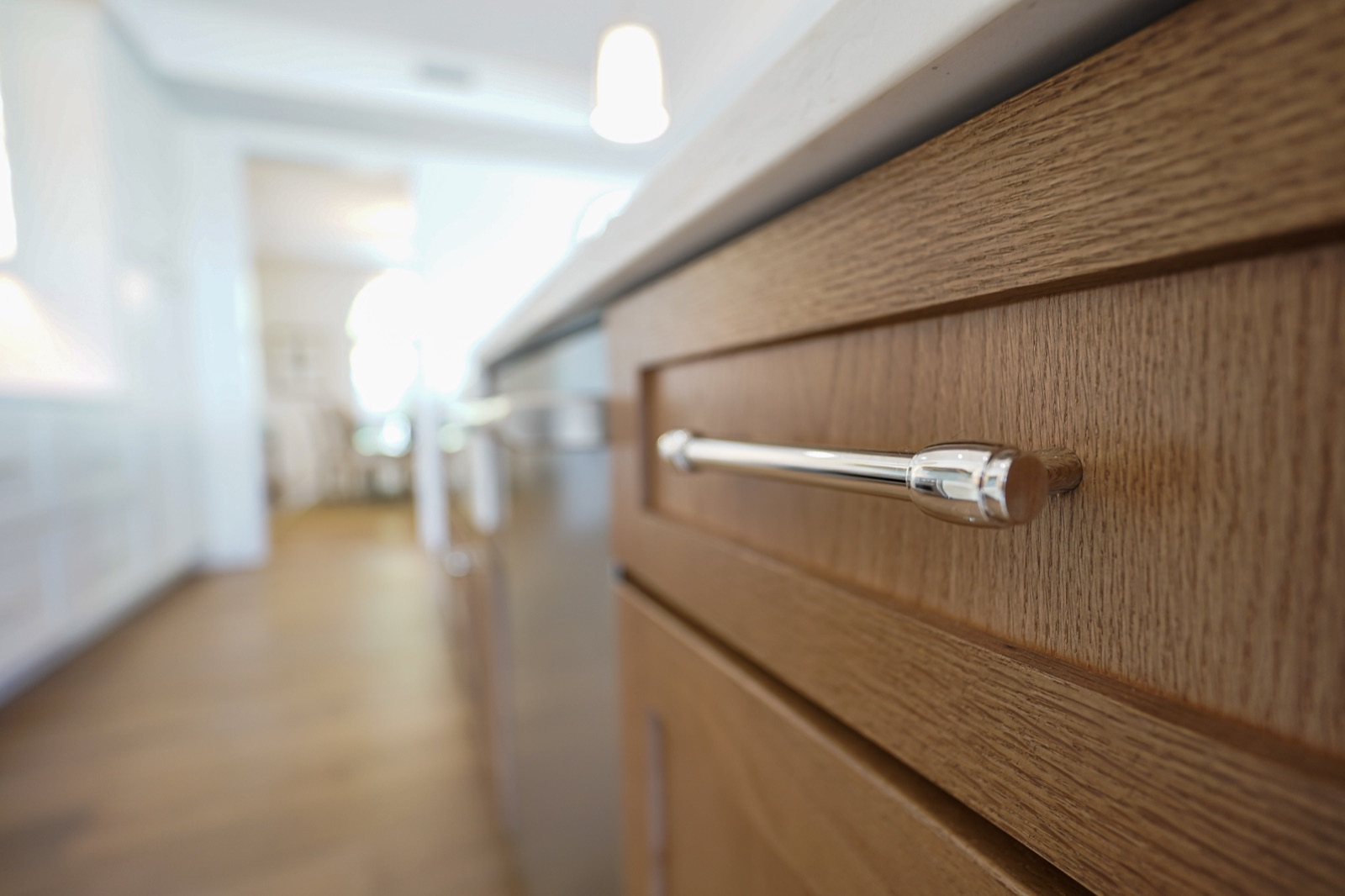Brushed bar pull on a stained oak drawer by Shoreline Cabinet Company, Wilmington NC