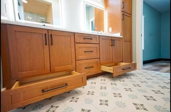 Cherry cabinet with a hidden toe-kick drawer by Shoreline Cabinet Company, Wilmington NC