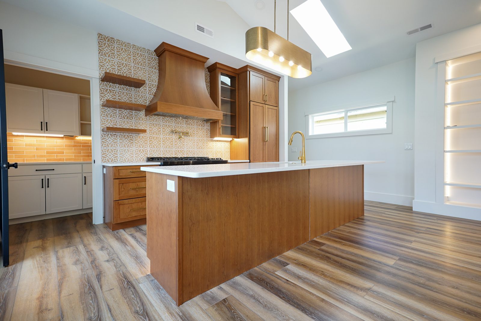 Cherry kitchen island facing the range wall by Shoreline Cabinet Company, Wilmington NC