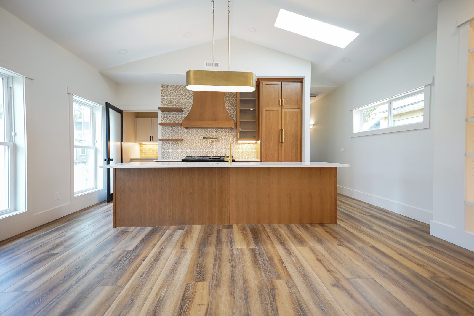 Cherry kitchen island under a vaulted ceiling by Shoreline Cabinet Company, Wilmington NC