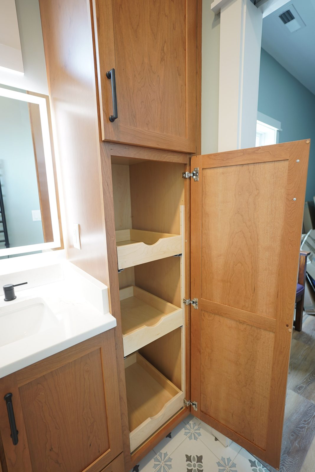 Cherry linen tower with pull-out shelves by Shoreline Cabinet Company, Wilmington NC