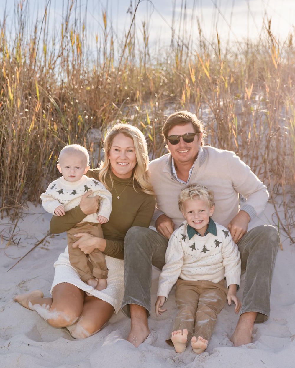 Josh and Liz Cleghorn, owners of Shoreline Cabinet Company in Wilmington, NC, with their children on a North Carolina beach