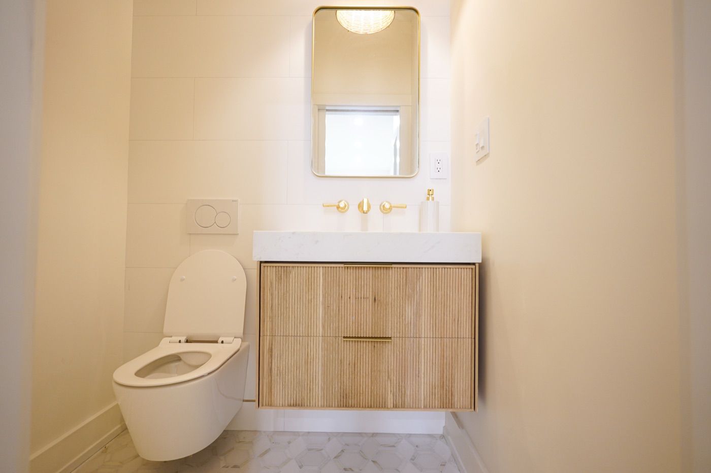 Floating white oak vanity in a powder room by Shoreline Cabinet Company