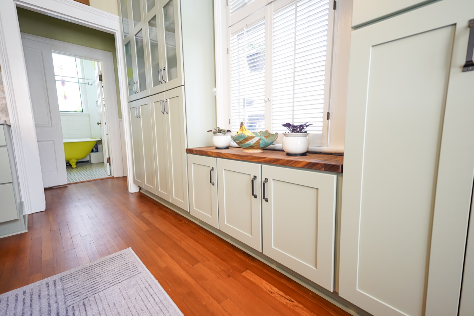 Glass-front hutch over a wood counter by Shoreline Cabinet Company, Wilmington NC