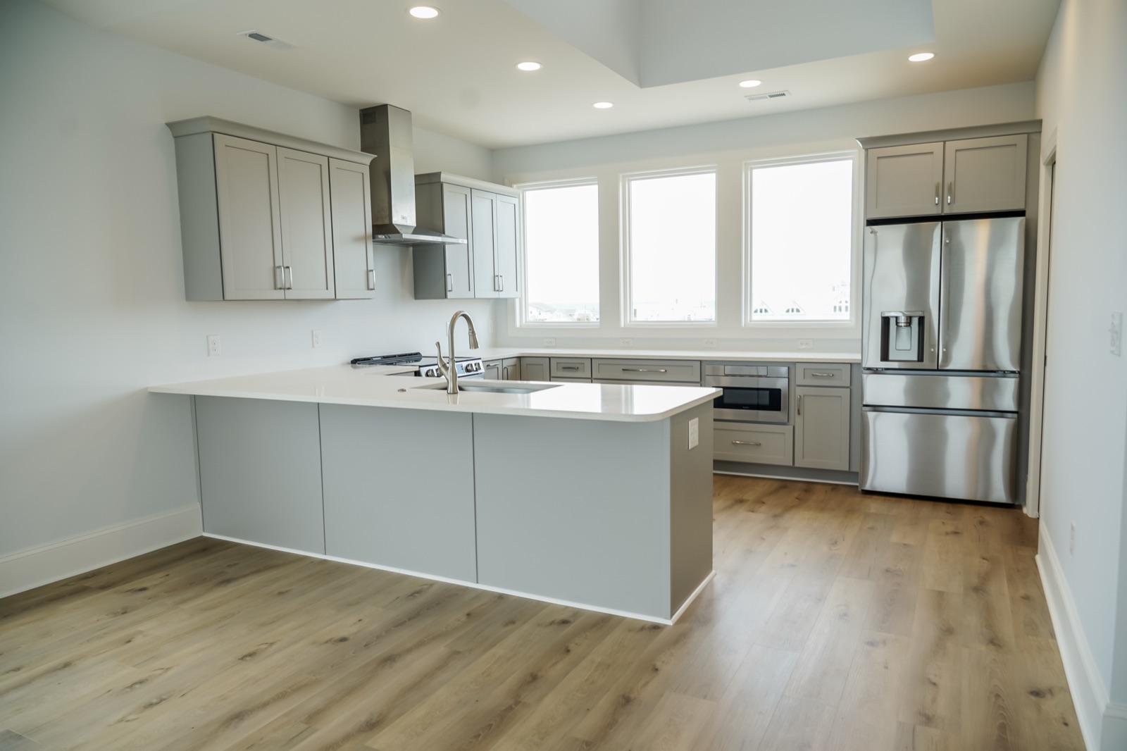 Grey shaker kitchen in a new-construction home by Shoreline Cabinet Company, Wilmington NC