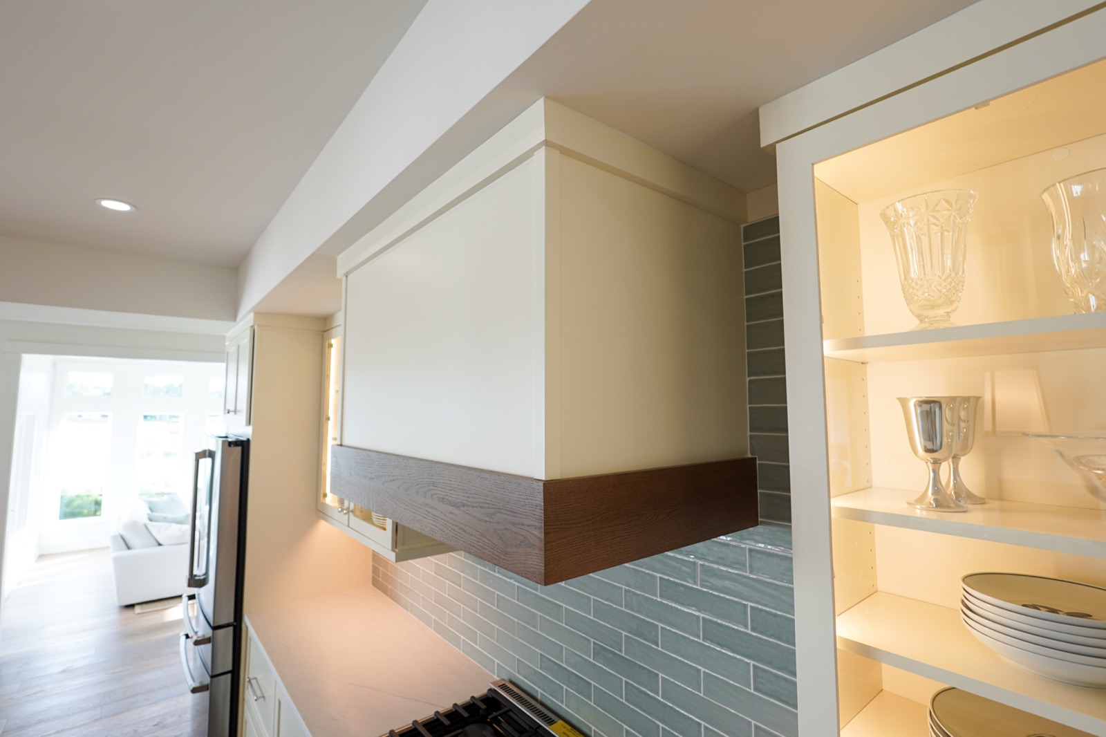 Lit glass-front cabinet with open shelving by Shoreline Cabinet Company, Wilmington NC