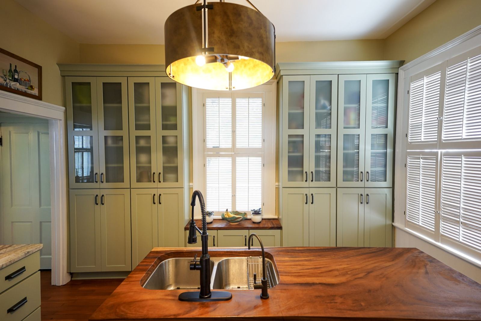 Live-edge wood island top with an undermount sink by Shoreline Cabinet Company, Wilmington NC