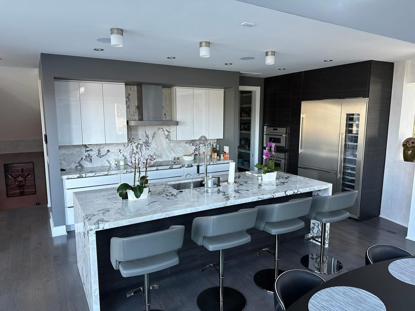 Modern grey kitchen with a marble waterfall island by Shoreline Cabinet Company, Wilmington NC