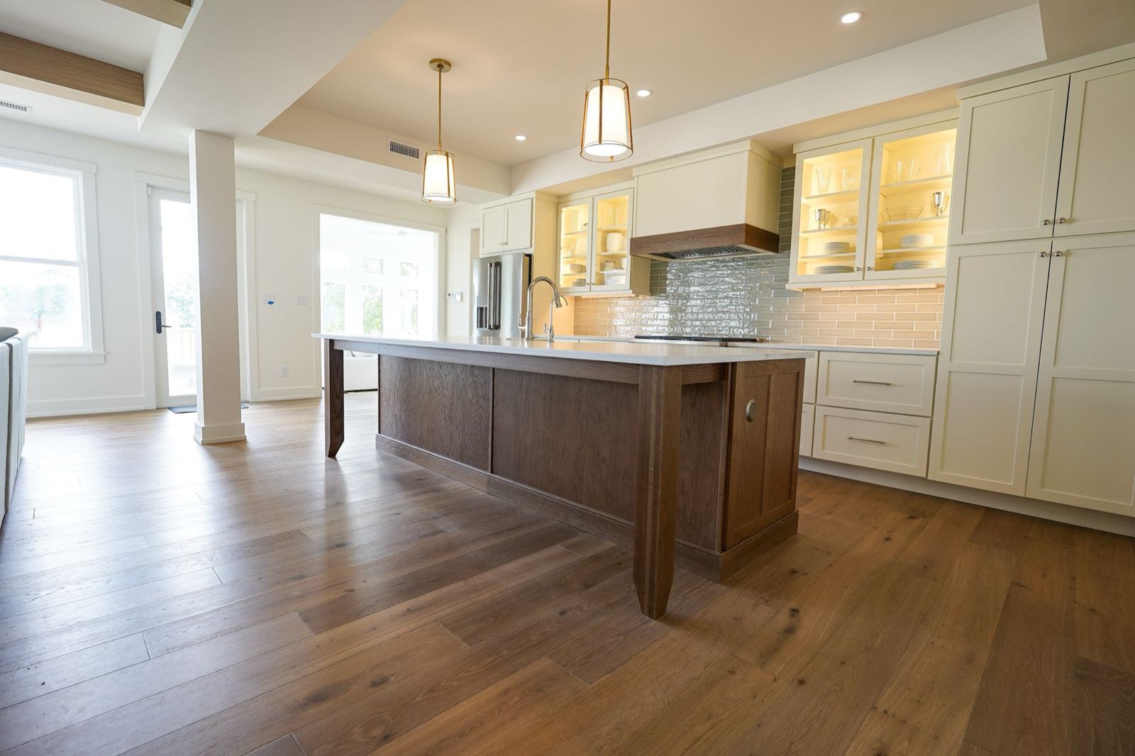 Open-plan kitchen with oak island by Shoreline Cabinet Company, Wilmington NC