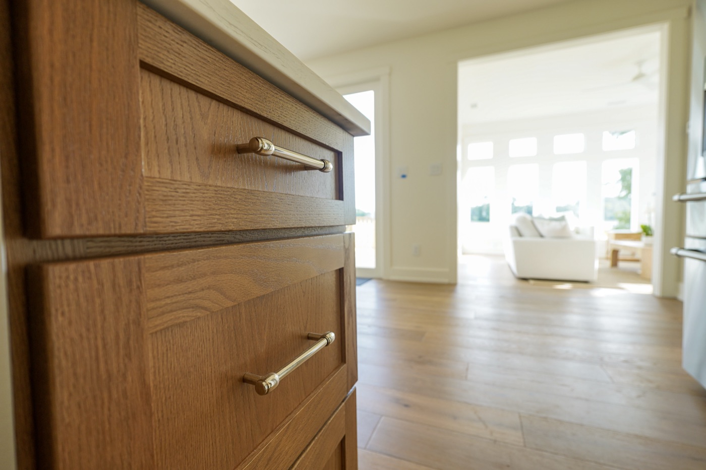 Close-up of stained oak drawer fronts with brushed pulls by Shoreline Cabinet Company, Wilmington NC