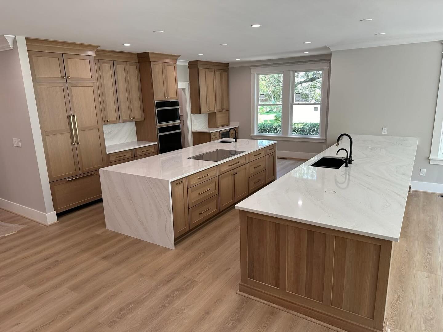 Two walnut waterfall kitchen islands by Shoreline Cabinet Company, Wilmington NC