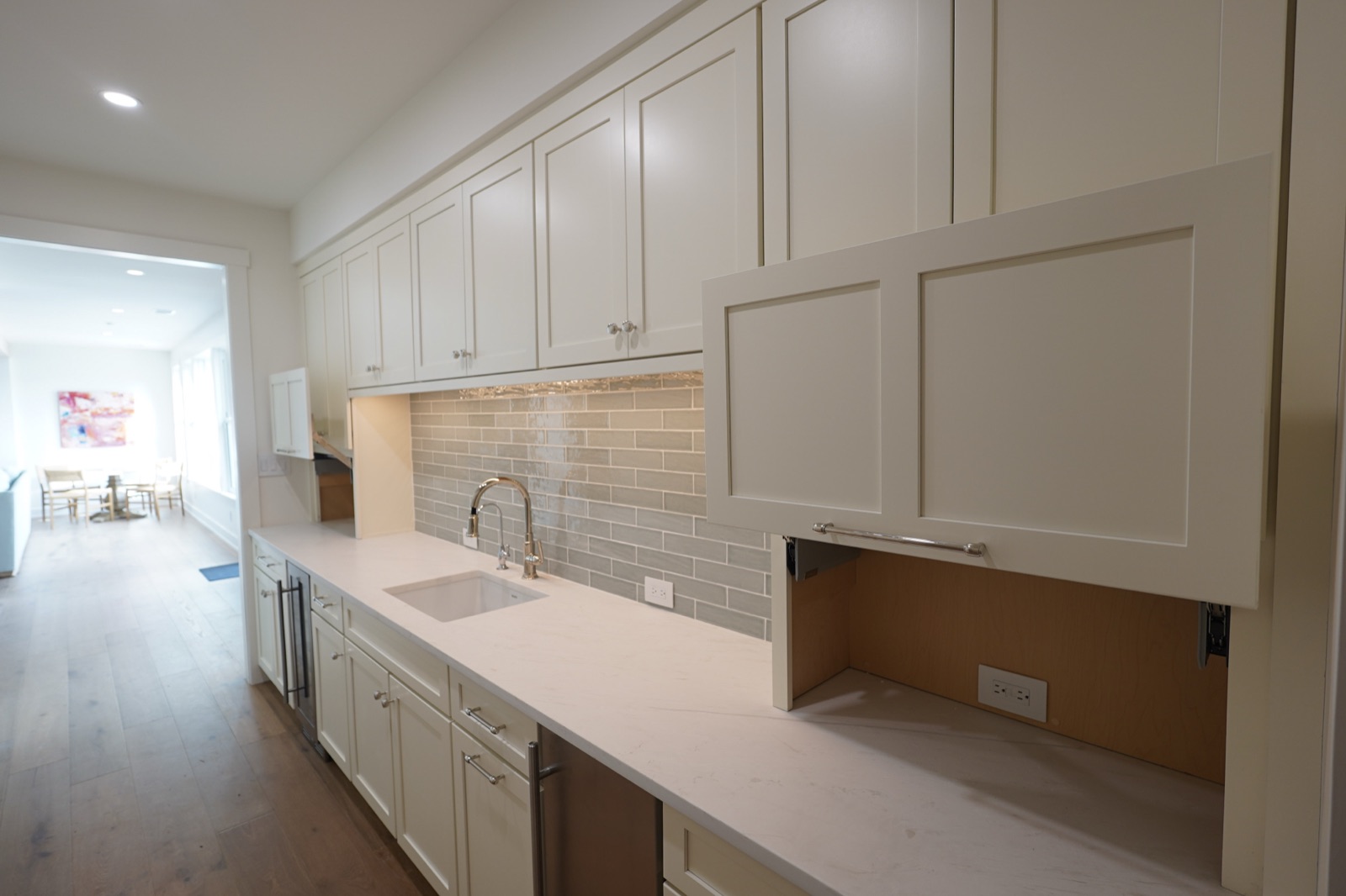 White galley kitchen with subway tile and an appliance garage by Shoreline Cabinet Company, Wilmington NC
